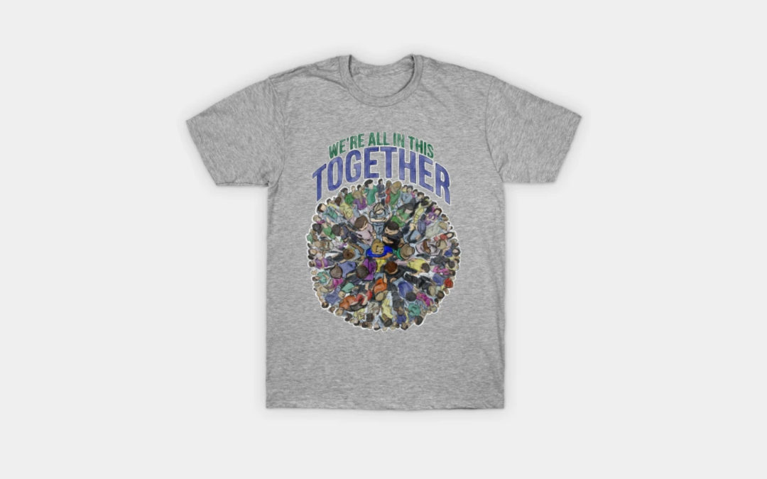 A product image of a tshirt with the phrase "We're all in this together" above a artwork of a globe made up of a variety of different people